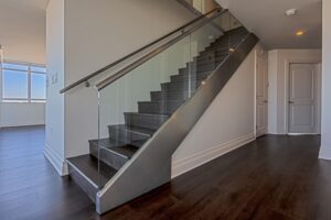 Photo of a residential staircase with glass railings in a modern home