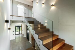 Photo of beautiful custom glass stair railings installed in a modern entryway in a luxury house