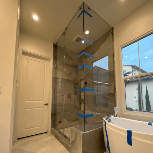 Floor-to-ceiling glass shower door installation